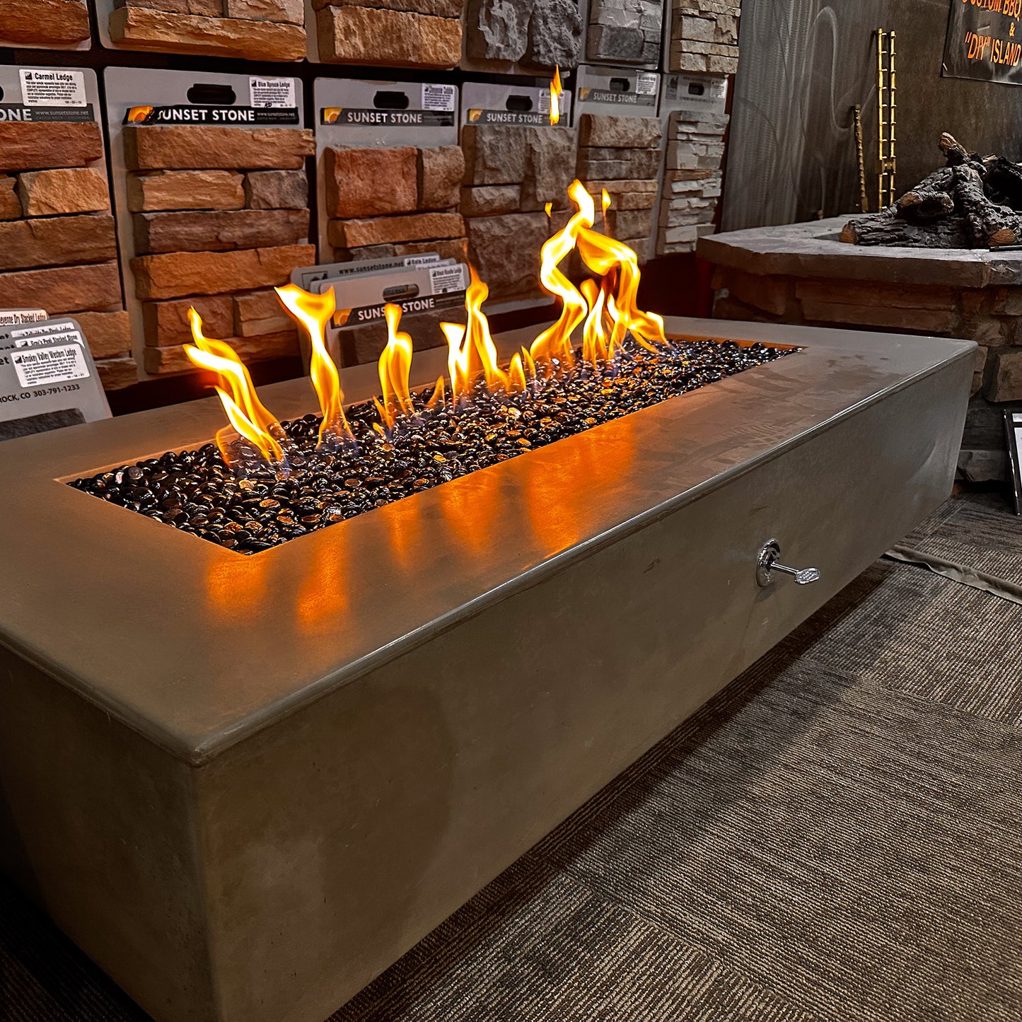 Del Mar Gas Fire Pit lit in the Fire Pit Outfitters showroom.
