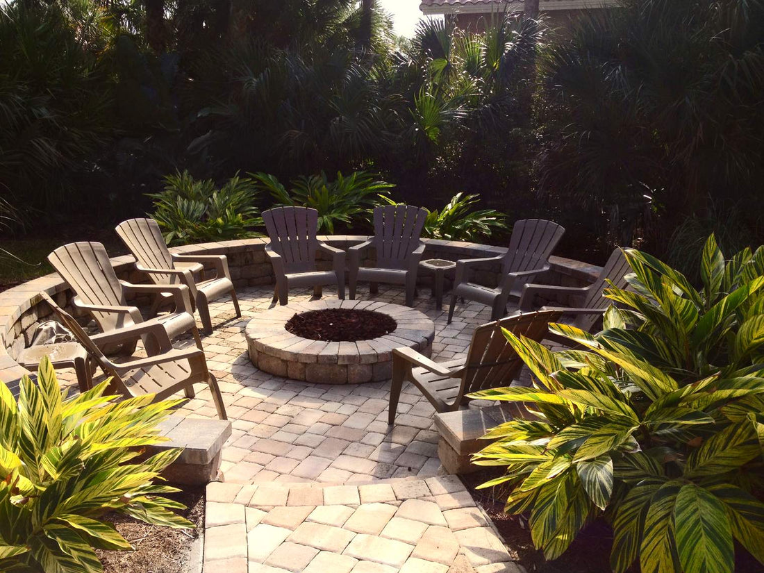 A stone fire pit surrounded by chairs