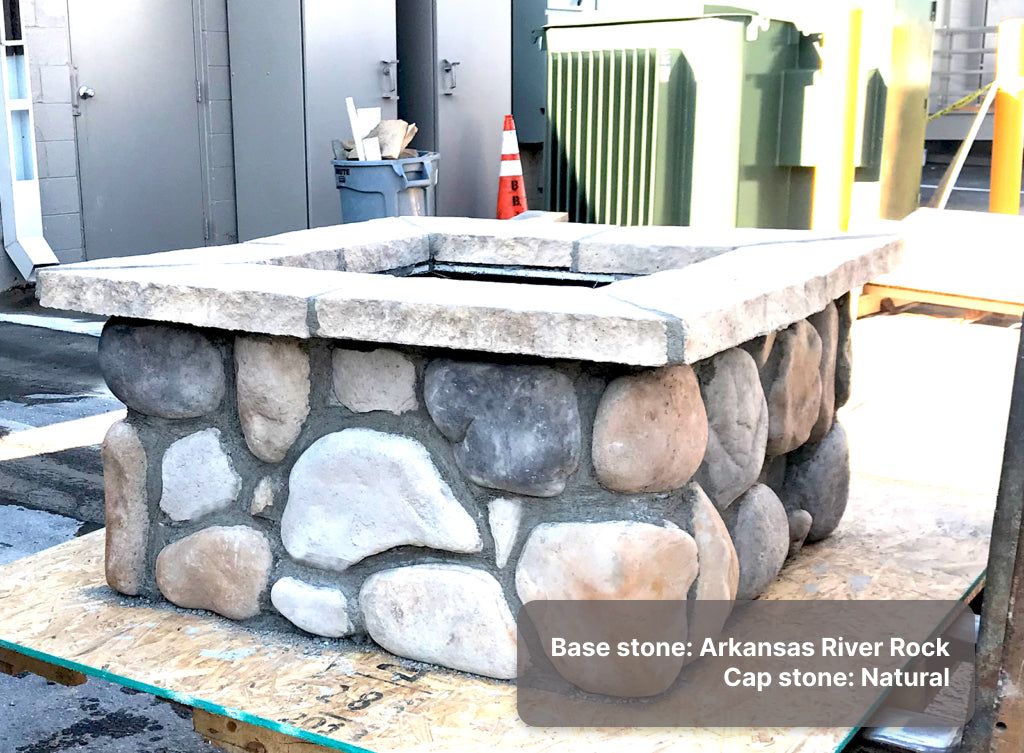 Custom stone fire pit with "Arkansas" river rock base and "Natural" caps