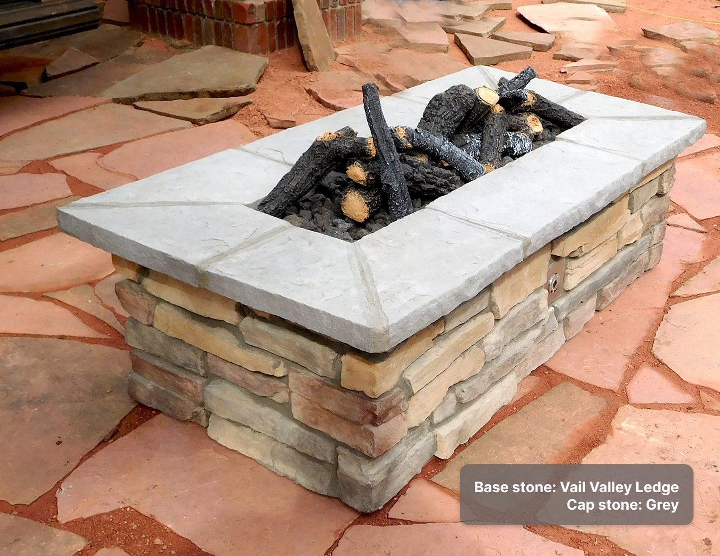 Custom stone fire pit with "Vail Valley Ledge" base & "Grey" caps