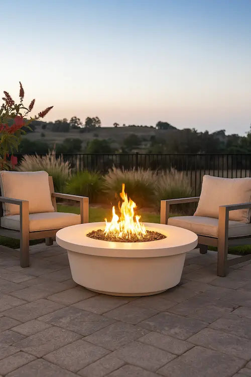 Outdoor patio with Tempe gas fire pit table and chairs, surrounded by nature.