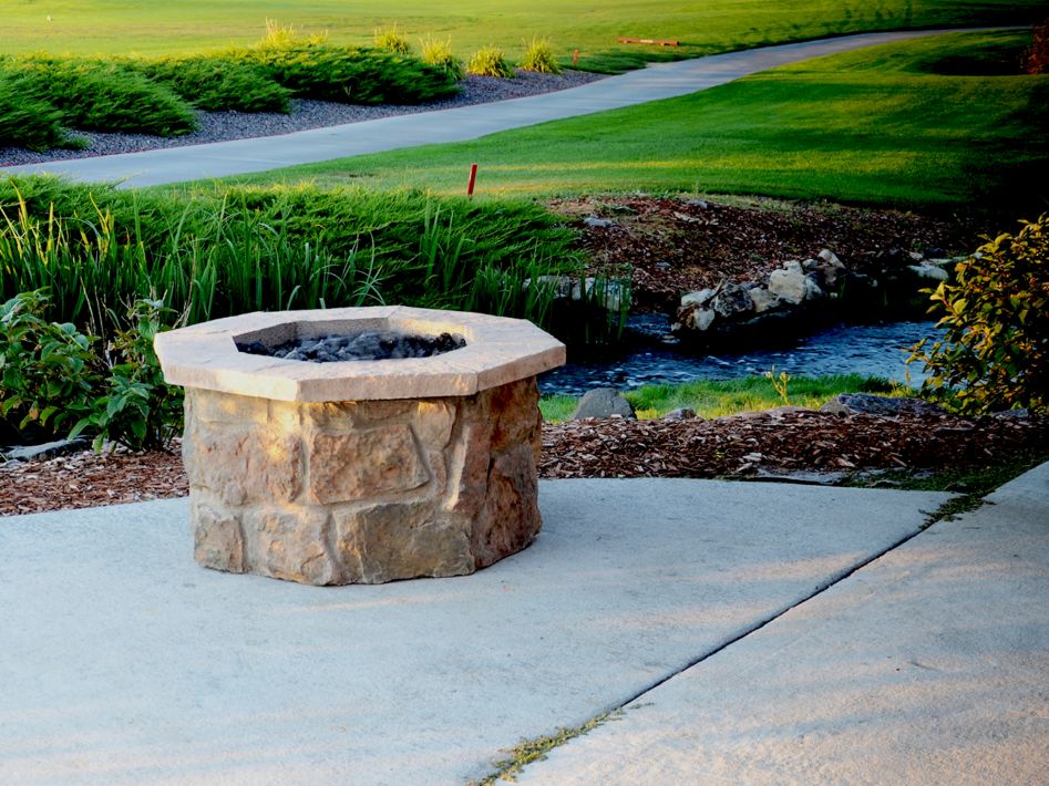 36" octagon custom stone gas fire pit with "moss rock base" and  "natural cap stones