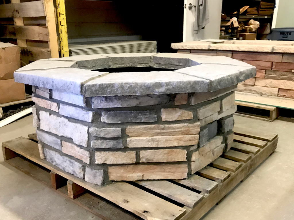 A Custom Octagon Fire Pit Kit 33″ with stonework applied.