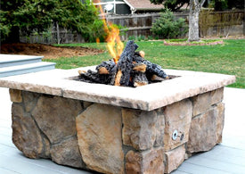 Custom stone fire pit with "Sienna" moss rock base and "Brown" cap stones